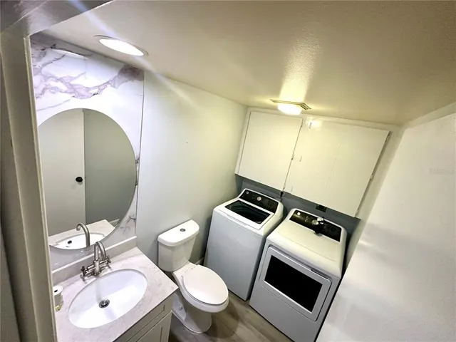 a bathroom with a toilet a sink and mirror