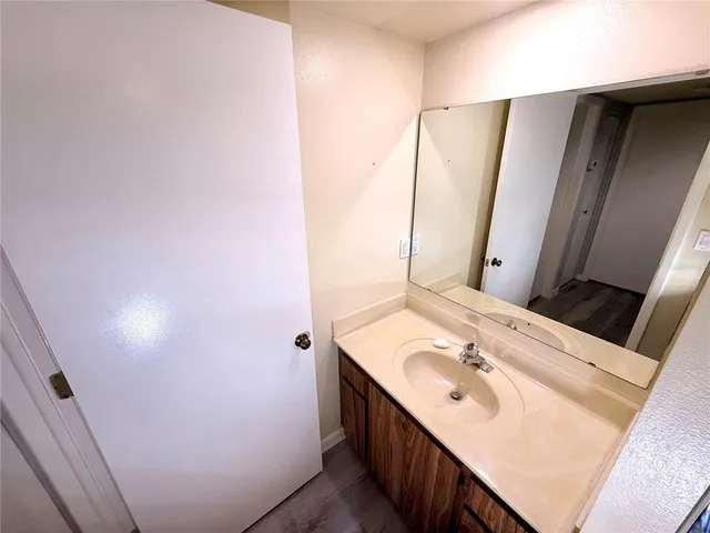 a bathroom with a sink a mirror and vanity