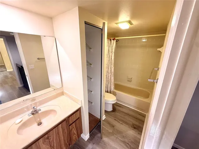 a bathroom with a sink mirror toilet and bathtub