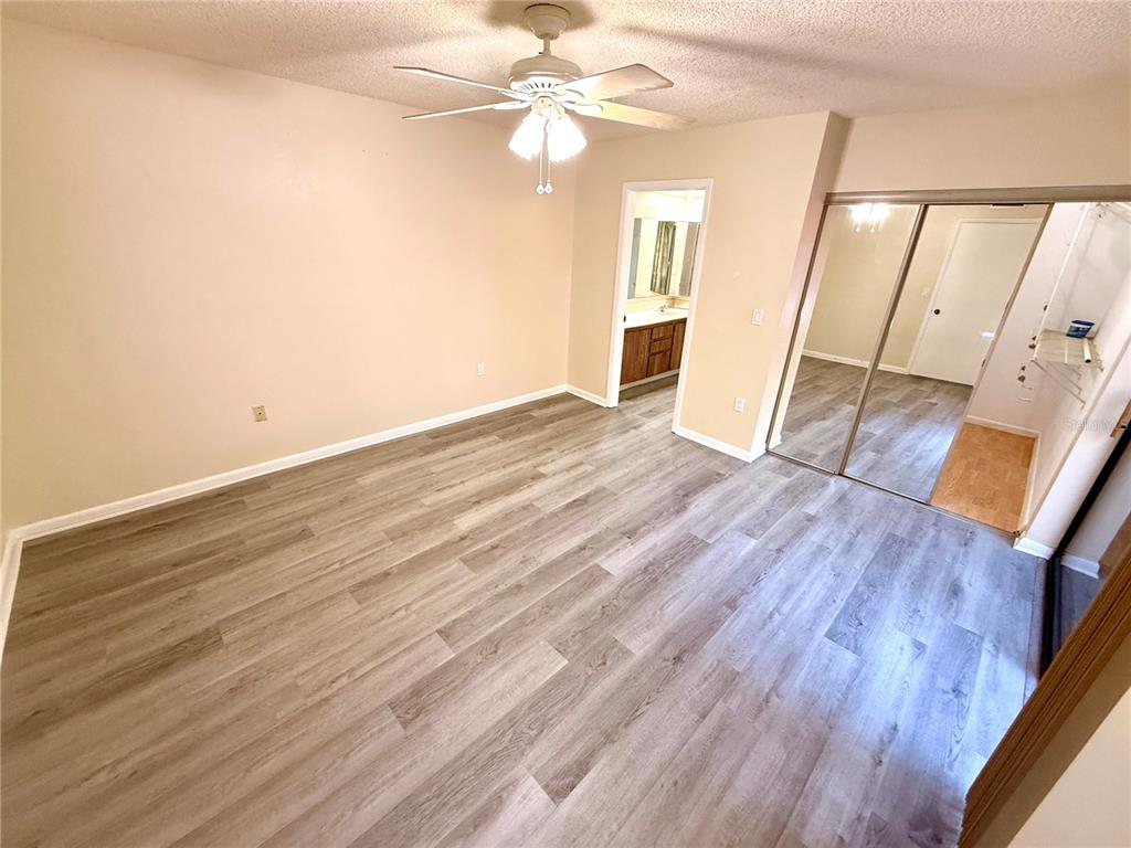 2727 14th Court Palm Harbor, FL 34684 - Photo 25 of 42 wooden floor in an empty room with a window
