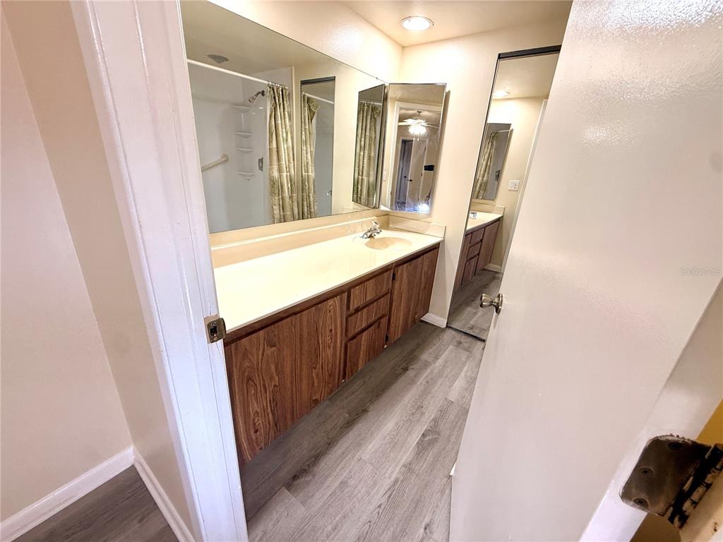 2727 14th Court Palm Harbor, FL 34684 - Photo 29 of 42 a bathroom with double vanity and mirrors