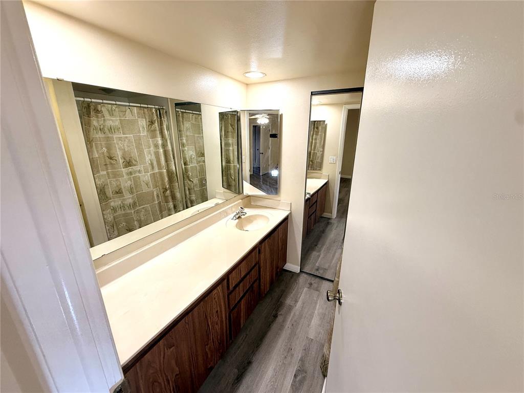2727 14th Court Palm Harbor, FL 34684 - Photo 34 of 42 a bathroom with a double vanity sink and a mirror