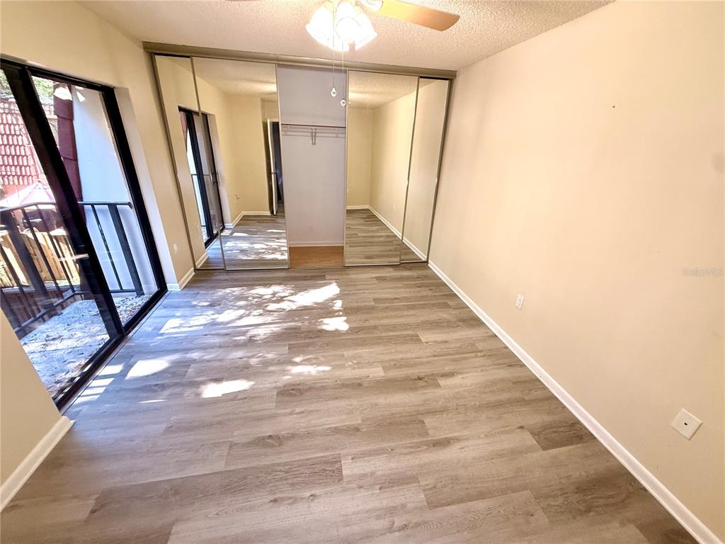 2727 14th Court Palm Harbor, FL 34684 - Photo 35 of 42 a view of a hallway with wooden floor and a chandelier