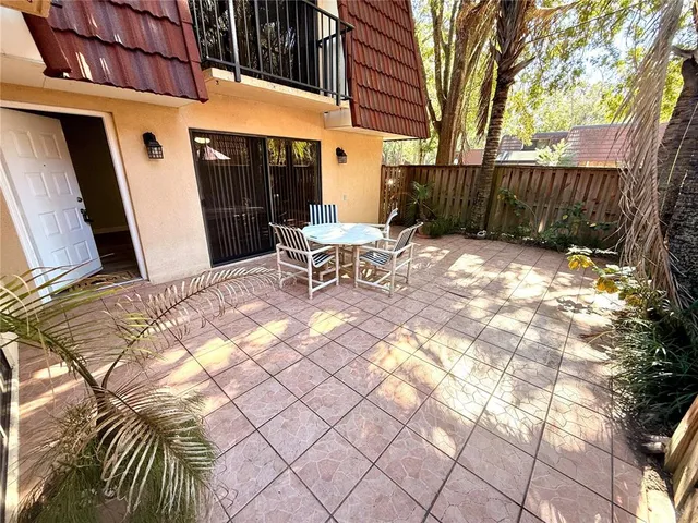 a view of a patio with a table and chairs