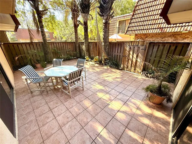 a backyard of a house with table and chairs