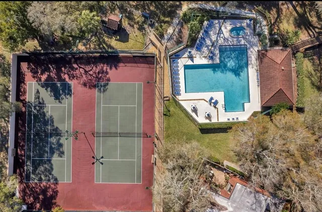 an aerial view of a house with a yard and trees