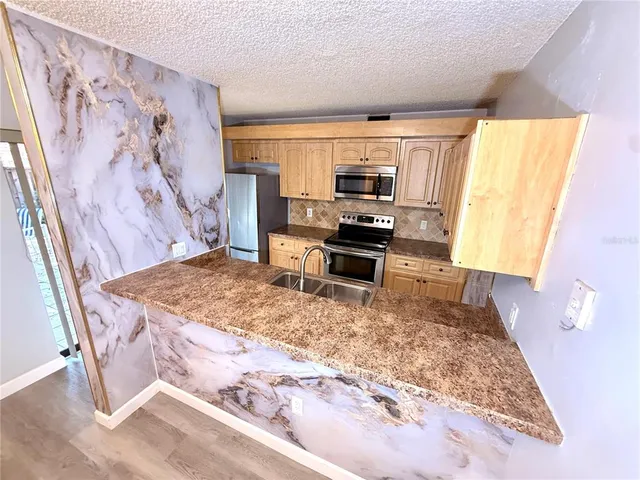 a view of a kitchen with microwave and cabinets