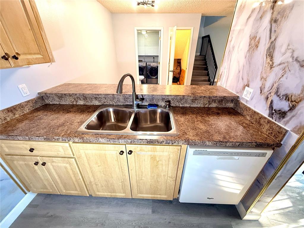 2727 14th Court Palm Harbor, FL 34684 - Photo 10 of 42 a kitchen with granite countertop a sink and a stove