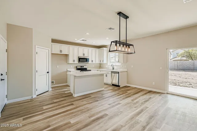 a kitchen with white cabinets stainless steel appliances and kitchen view