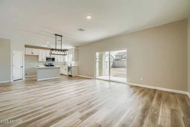a view of hallway with wooden floor