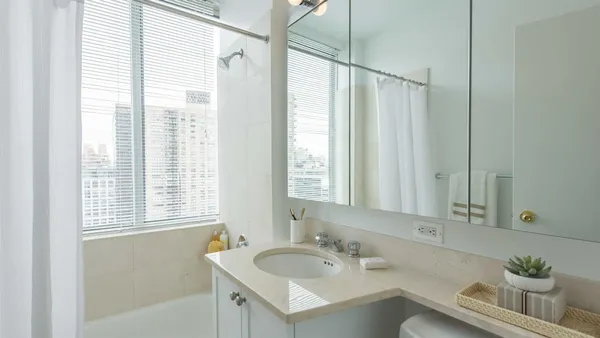 a bathroom with 2 sink tub and a mirror