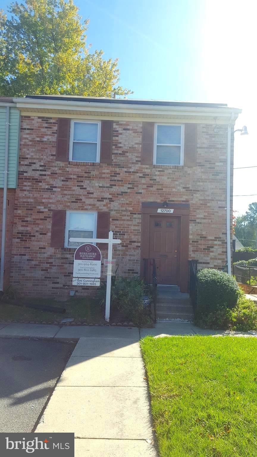 12700 Epping Terrace, Unit 8D Silver Spring, MD 20906 - Photo 1 of 6 a brick house with a small yard