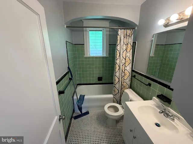a bathroom with a sink toilet and tub