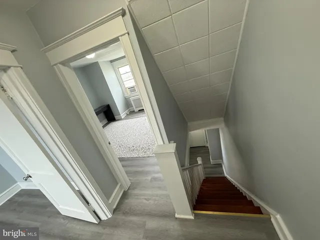 a view of entryway and hall with wooden floor