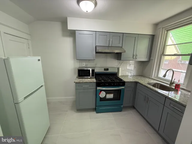 a kitchen with a stove and a refrigerator