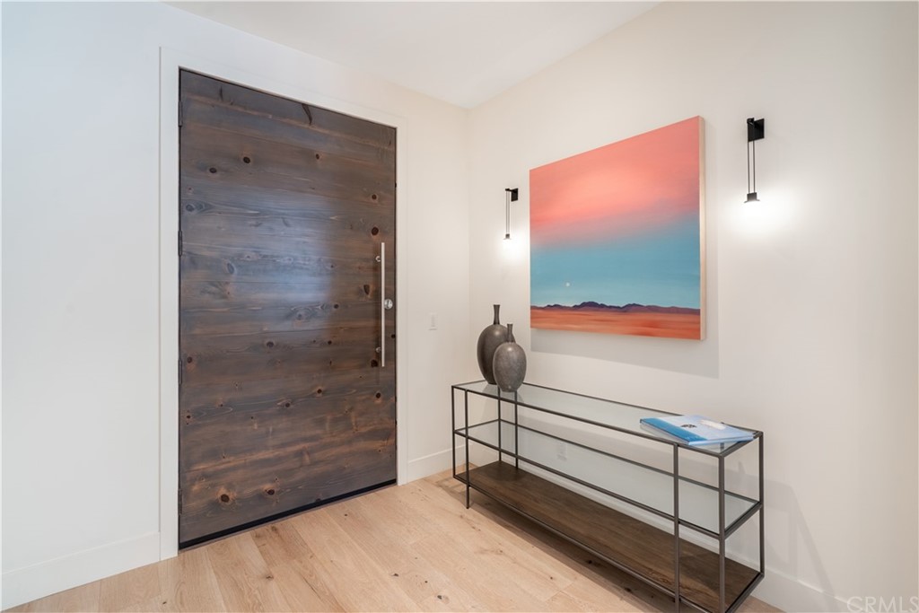 163 Broadway Costa Mesa, CA 92627 - Photo 51 of 56 Custom wood front door at the entry with a large closet.
