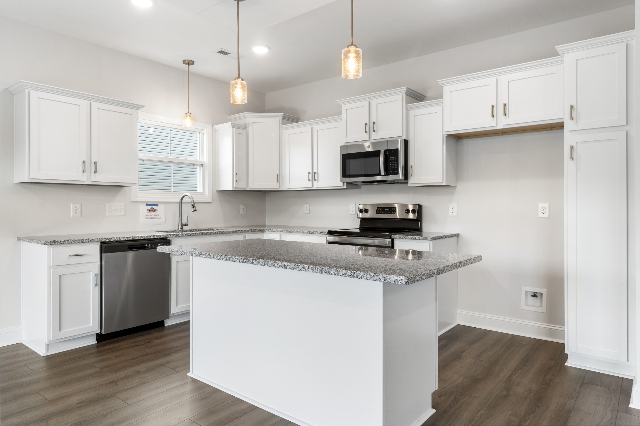 2616 Rafiki Drive Clarksville, TN 37042 - Photo 12 of 36 a kitchen with stainless steel appliances granite countertop a sink a stove a microwave and cabinets