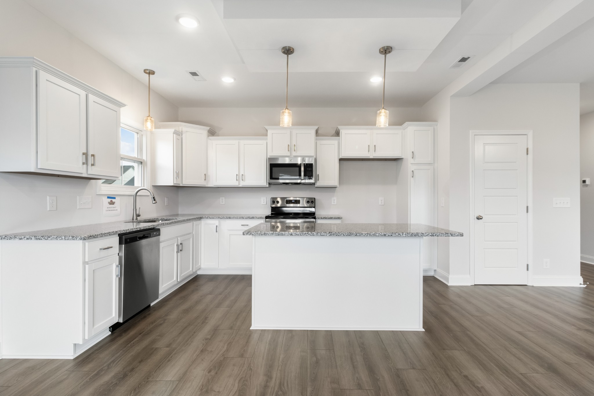 2616 Rafiki Drive Clarksville, TN 37042 - Photo 13 of 36 a kitchen with kitchen island granite countertop a sink cabinets and wooden floor