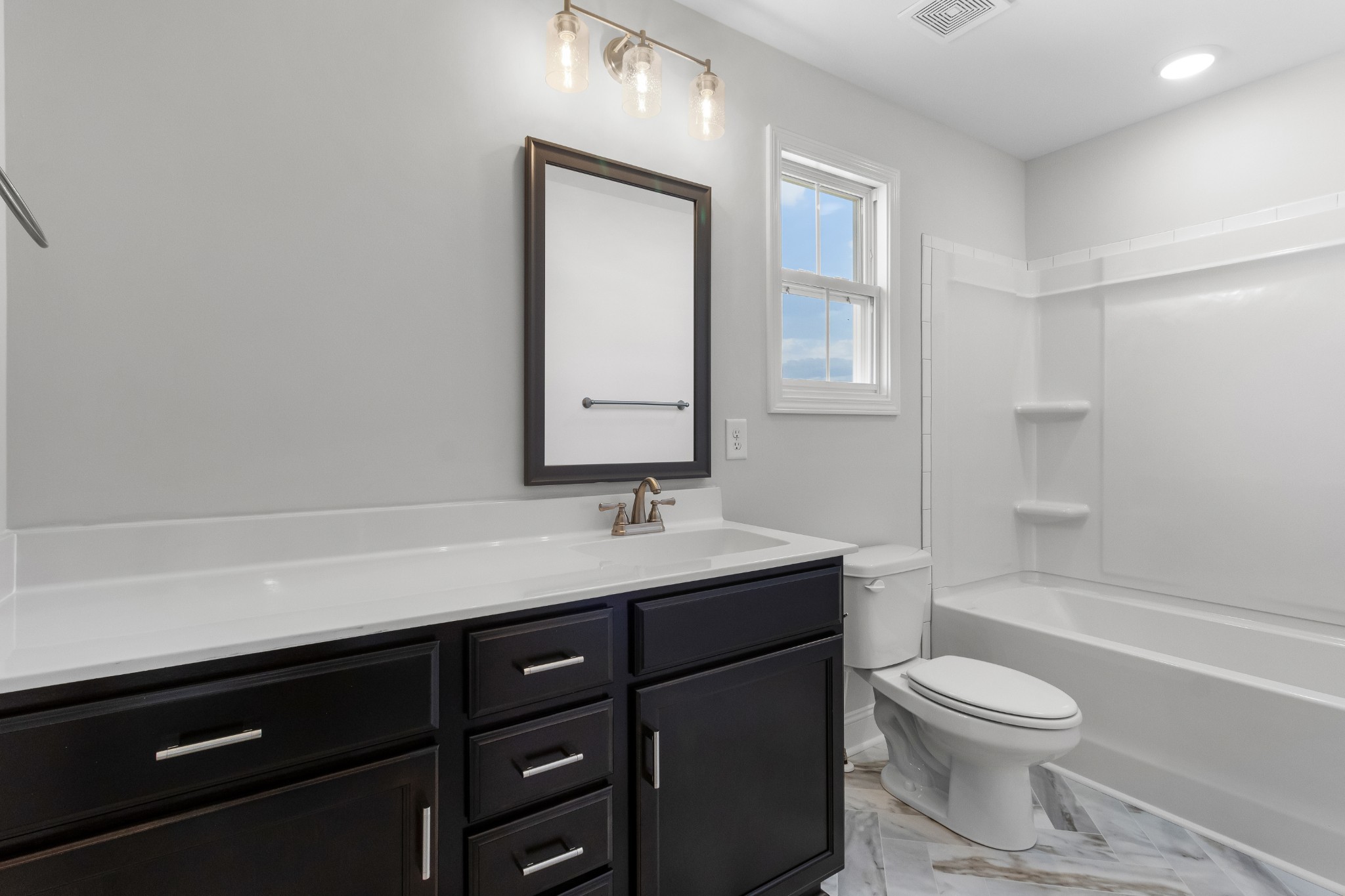 2616 Rafiki Drive Clarksville, TN 37042 - Photo 29 of 36 a bathroom with a toilet a sink a mirror and a bathtub