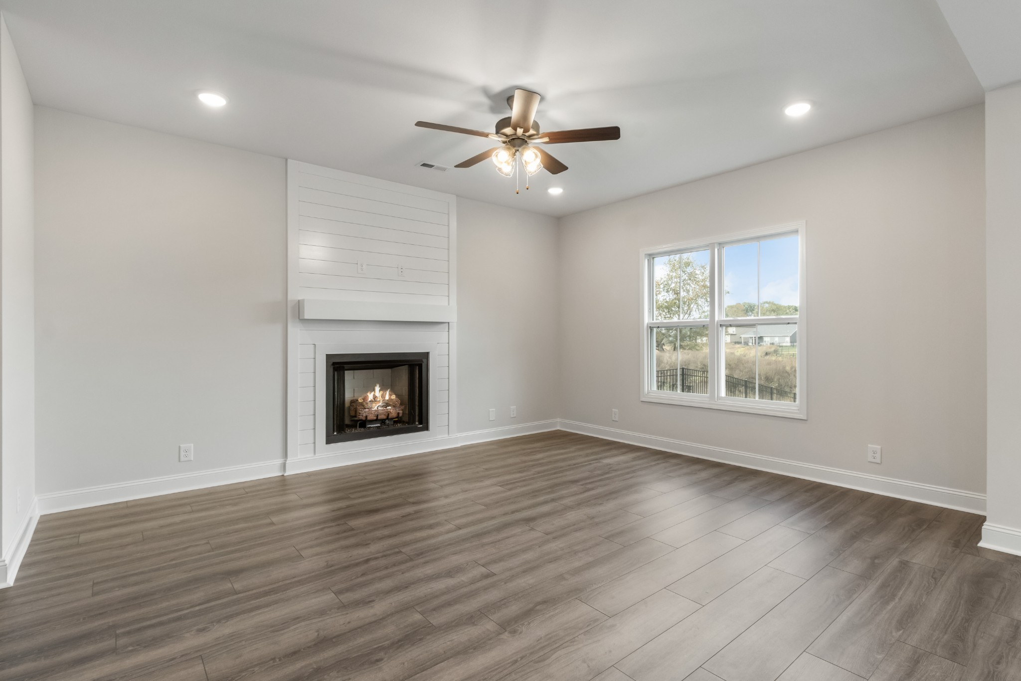 2616 Rafiki Drive Clarksville, TN 37042 - Photo 9 of 36 a view of an empty room with wooden floor fireplace and a window