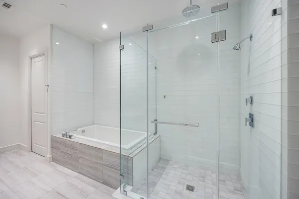a bathroom with a bathtub and a shower