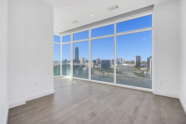 a view of a room with wooden floor