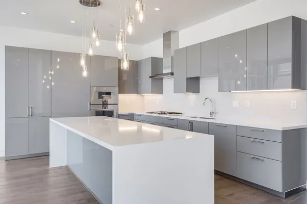 a large kitchen with kitchen island a sink stainless steel appliances and cabinets