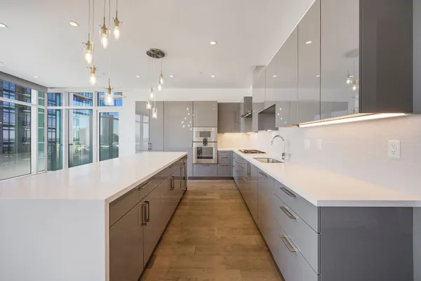 a large white kitchen with lots of counter top space