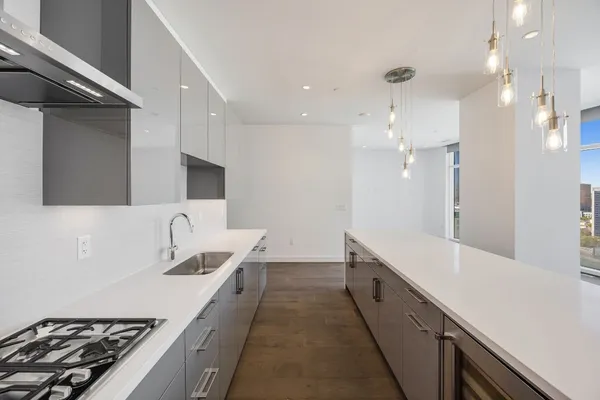 a bathroom with a sink a large mirror and a shower