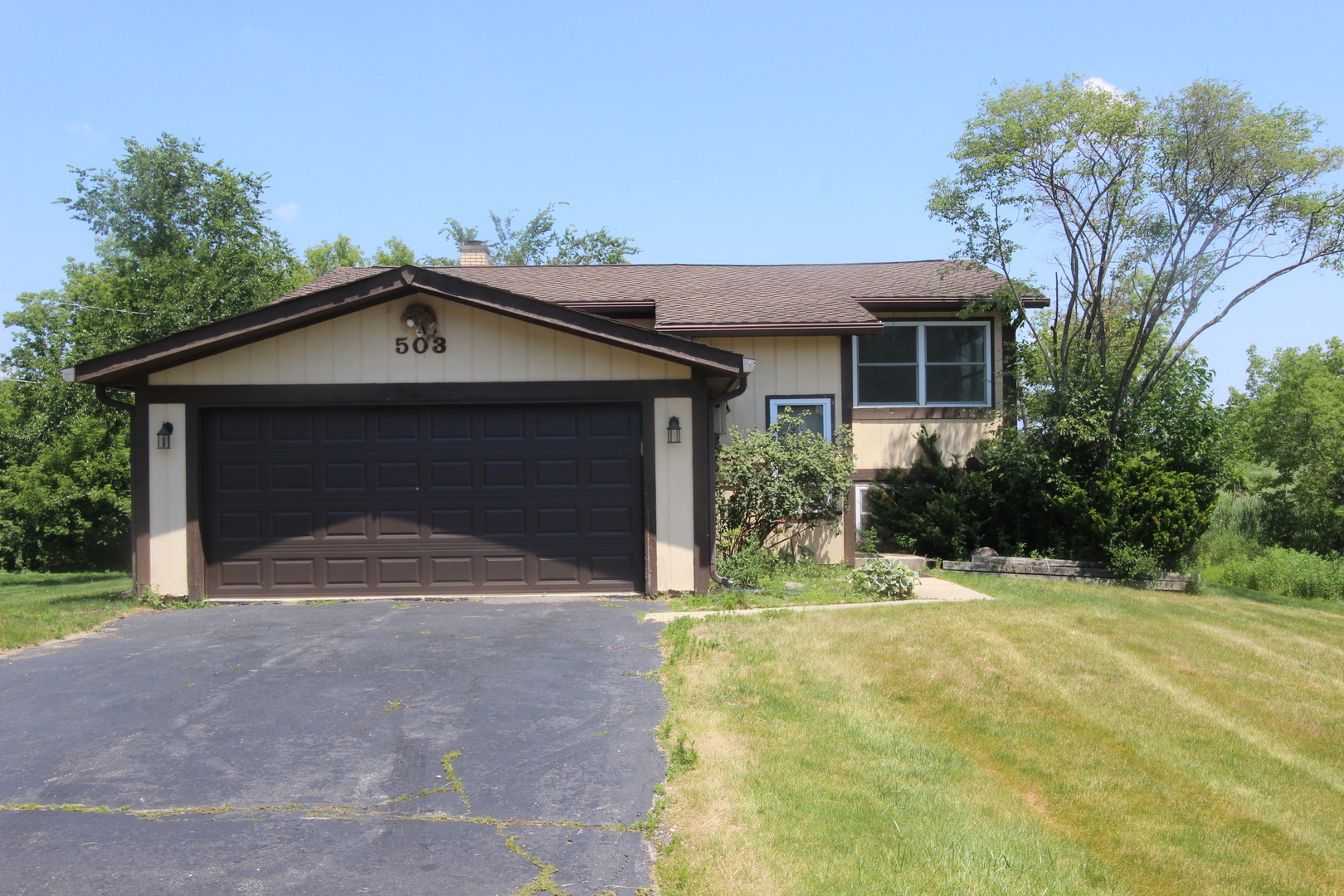 503 Plum Street Lake In The Hills, IL 60156 - Photo 1 of 20 a front view of a house with a yard and garage