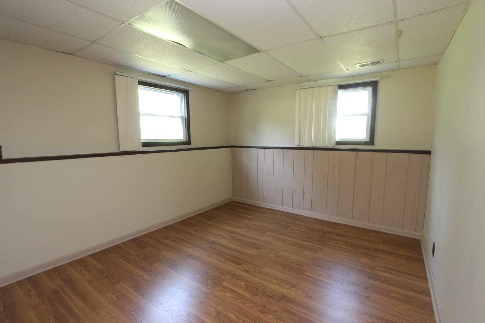 503 Plum Street Lake In The Hills, IL 60156 - Photo 14 of 20 an empty room with wooden floor and windows