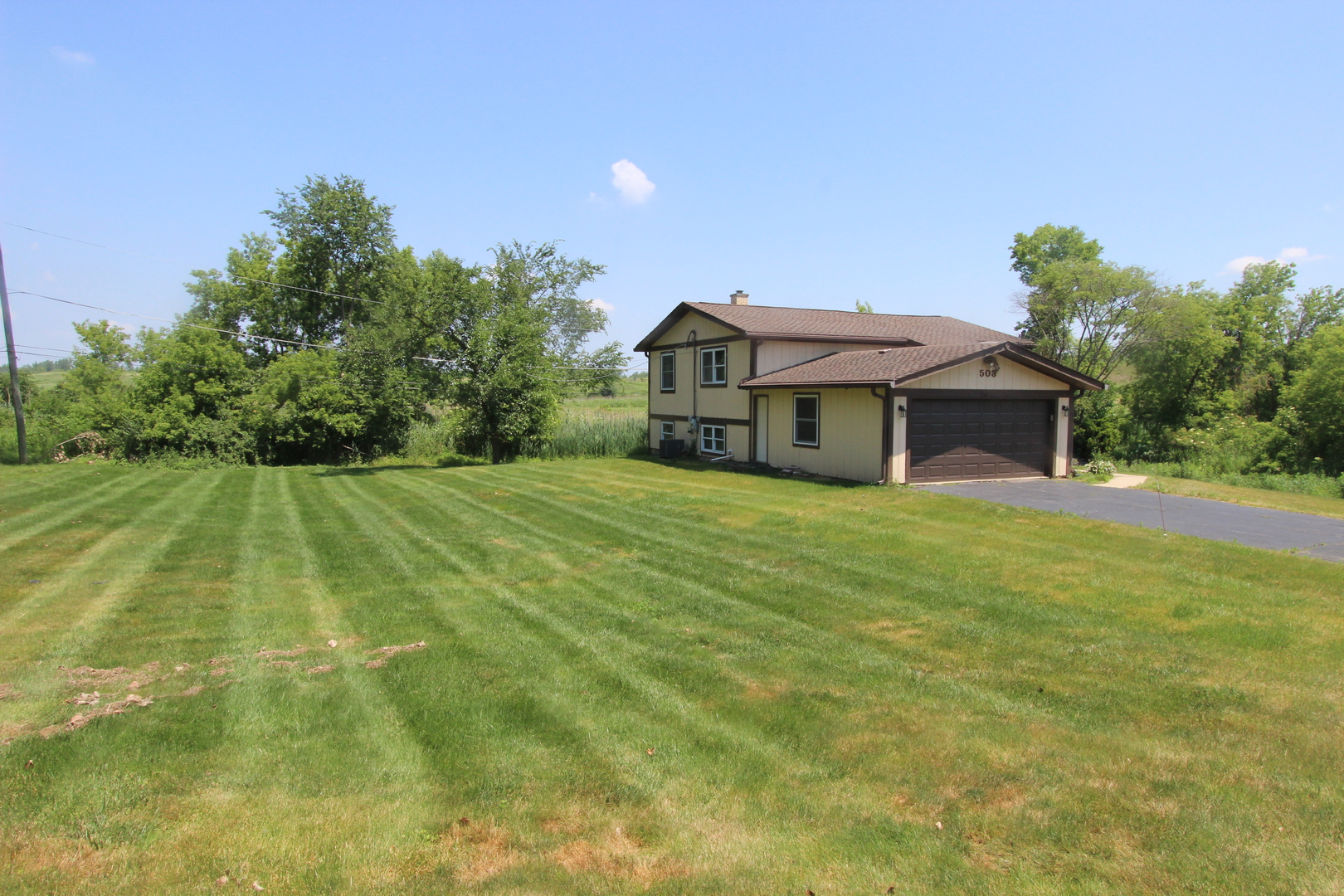 503 Plum Street Lake In The Hills, IL 60156 - Photo 20 of 20 a front view of a house with a garden