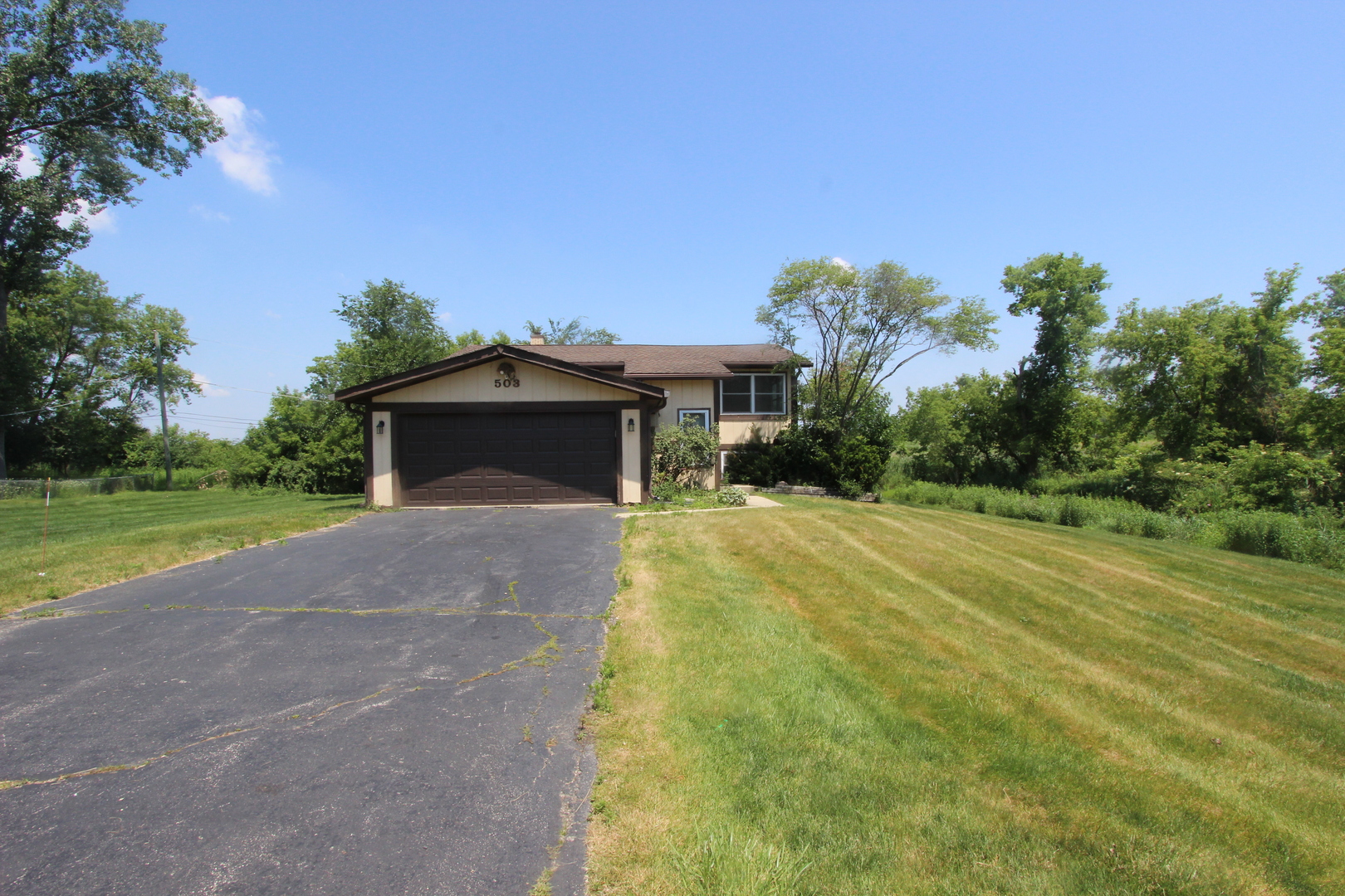 503 Plum Street Lake In The Hills, IL 60156 - Photo 2 of 20 a front view of a house with a yard and garage