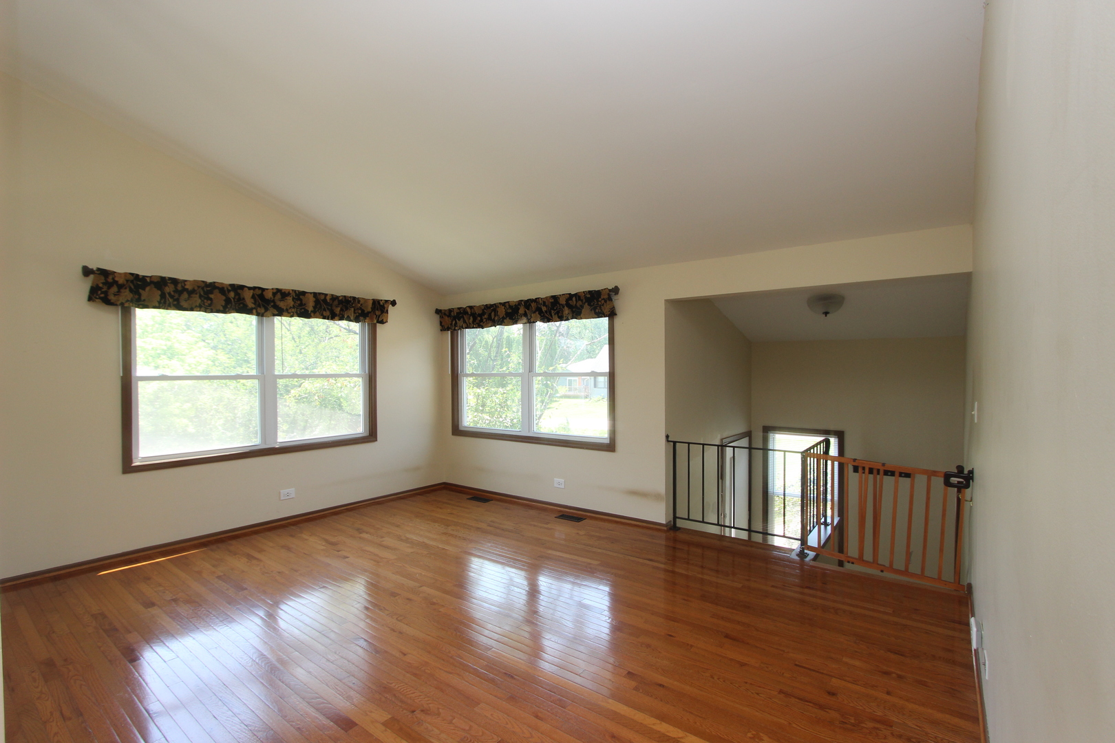 503 Plum Street Lake In The Hills, IL 60156 - Photo 3 of 20 an empty room with wooden floor and windows