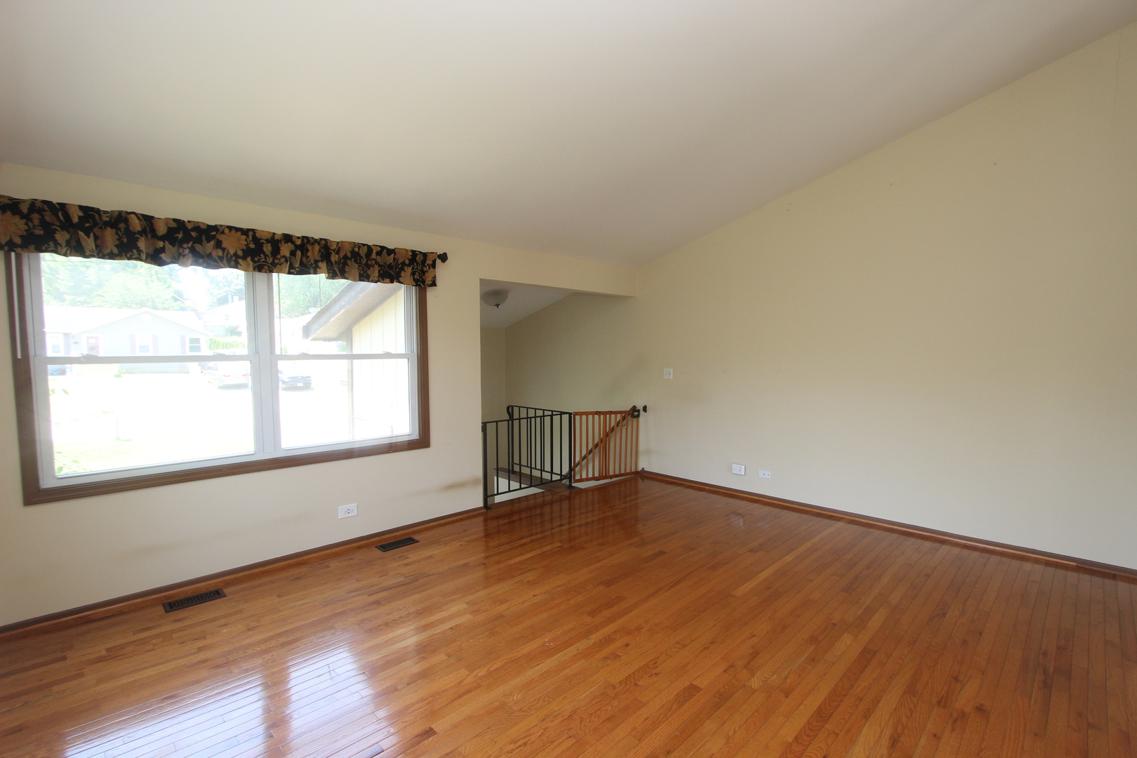 503 Plum Street Lake In The Hills, IL 60156 - Photo 4 of 20 an empty room with wooden floor and windows