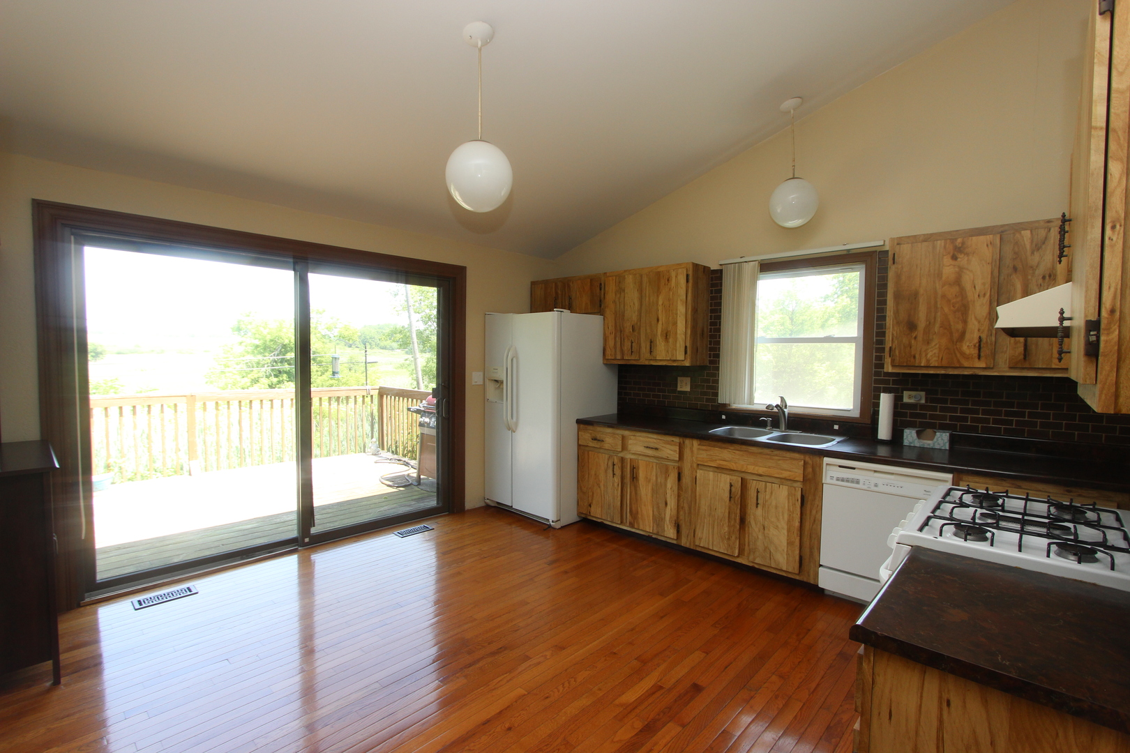 503 Plum Street Lake In The Hills, IL 60156 - Photo 6 of 20 a kitchen with stainless steel appliances granite countertop a stove a sink dishwasher a refrigerator and a stove with wooden floor