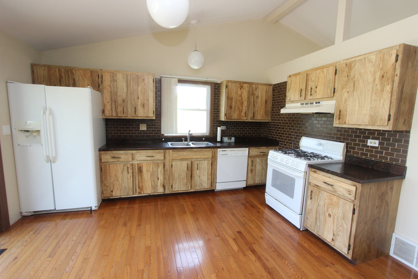 503 Plum Street Lake In The Hills, IL 60156 - Photo 7 of 20 a kitchen with granite countertop a white stove top oven sink and cabinets