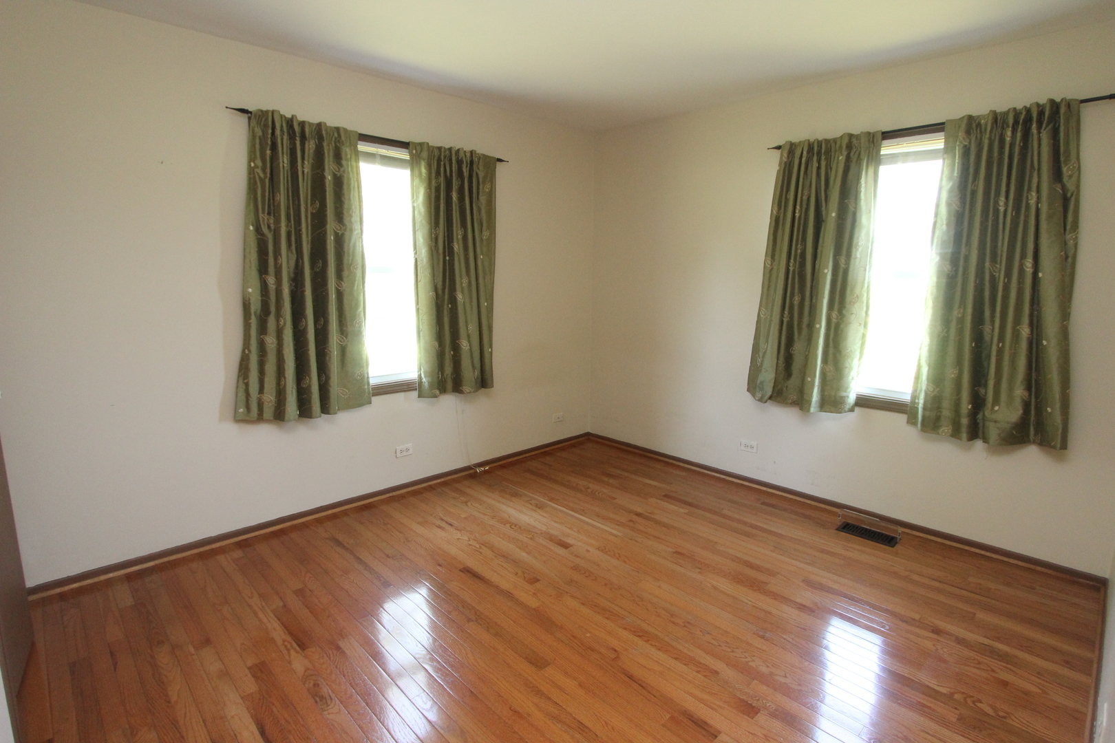 503 Plum Street Lake In The Hills, IL 60156 - Photo 9 of 20 an empty room with wooden floor and windows