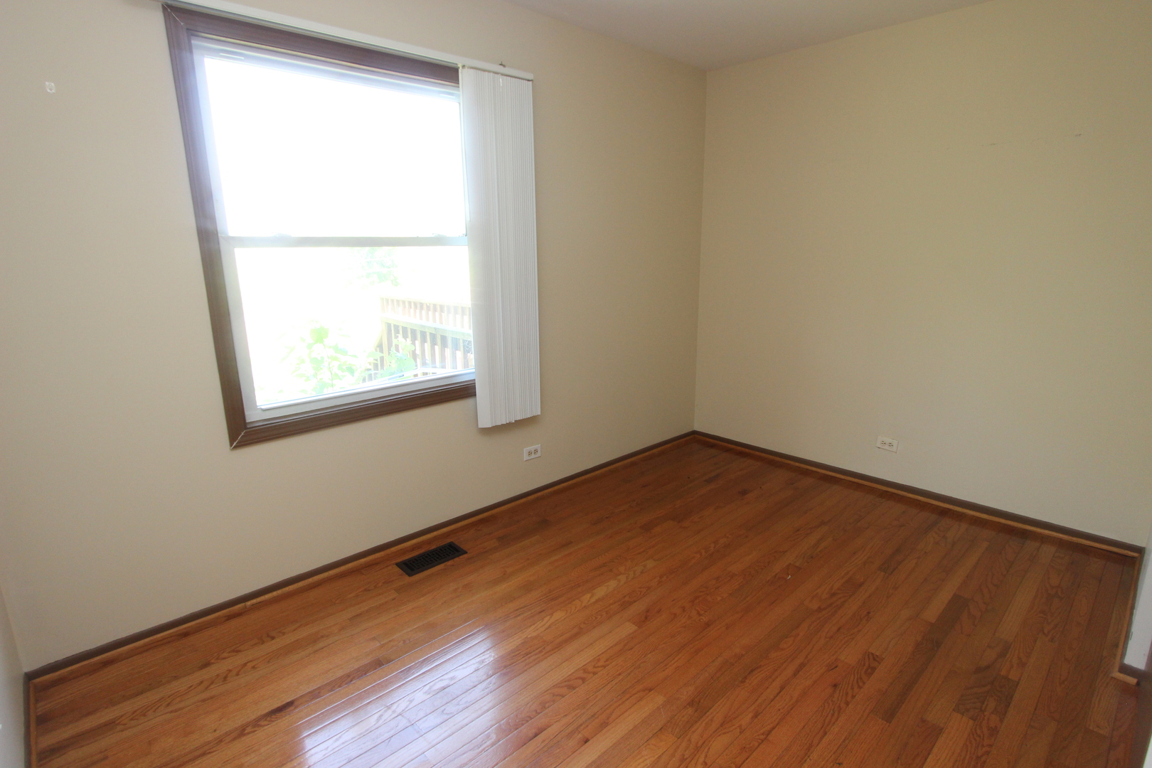 503 Plum Street Lake In The Hills, IL 60156 - Photo 10 of 20 an empty room with wooden floor and a window