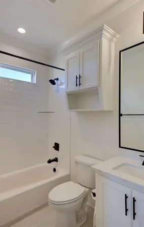 a bathroom with a toilet a sink a bath tub and shower