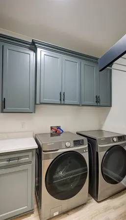 a utility room with sink dryer and washer