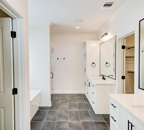 a bathroom with a double vanity sink toilet and shower