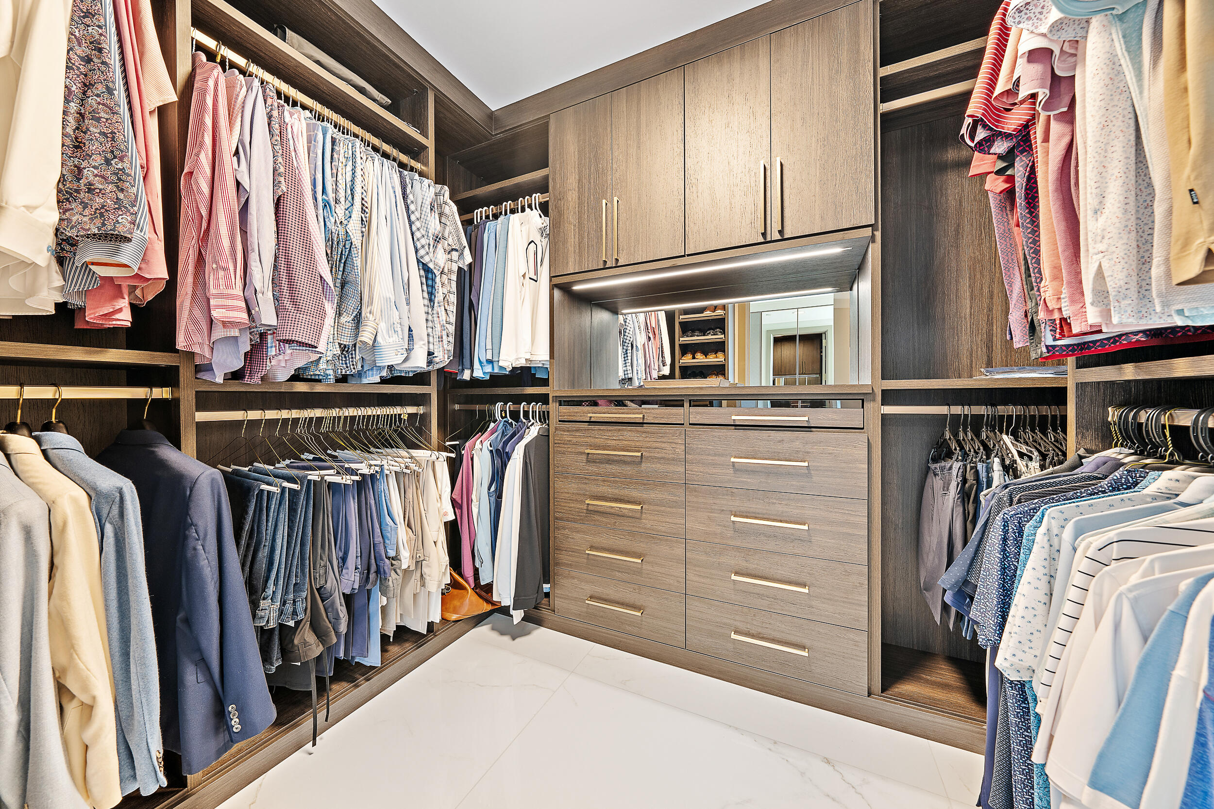 2720 Donald Ross Road, Unit 505 Palm Beach Gardens, FL 33410 - Photo 21 of 43 a view of walk in closet with clothes and shoes