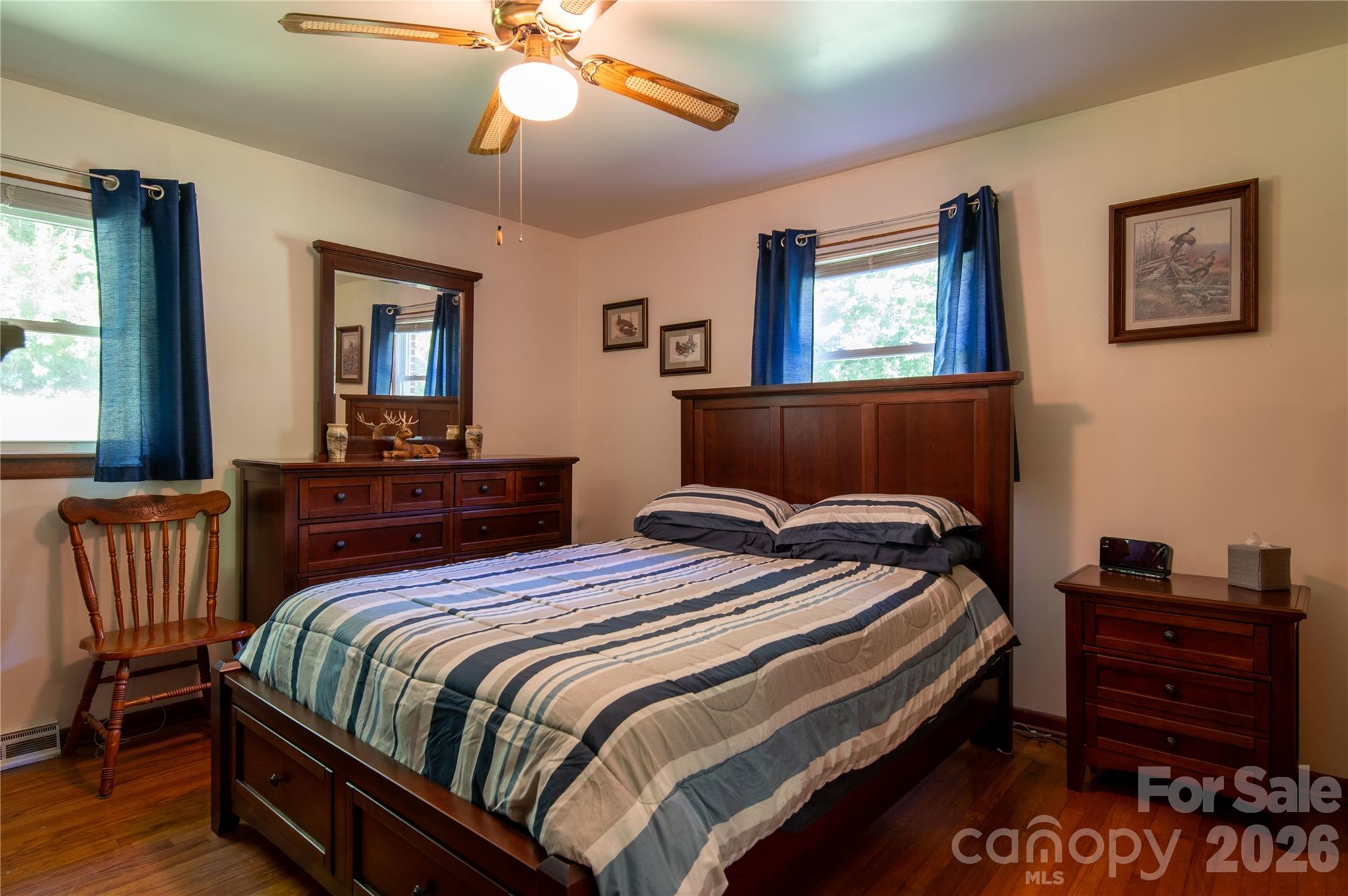40 Double Island Road Burnsville, NC 28714 - Photo 20 of 38 a bedroom with a bed and wooden floor
