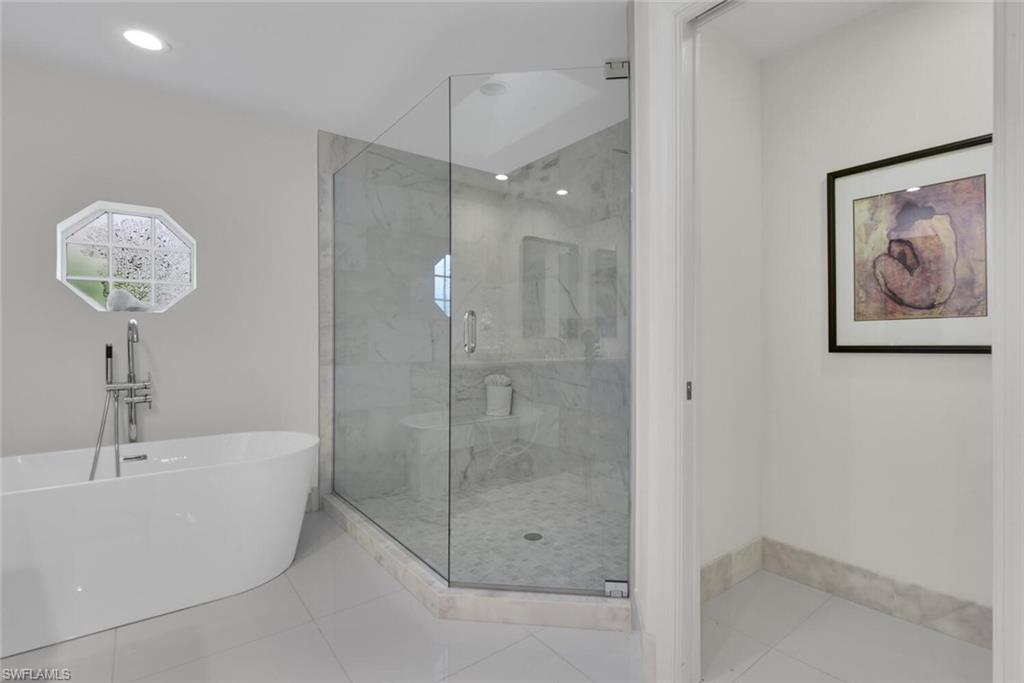 2124 Paget Circle, Unit 1 Naples, FL 34112 - Photo 12 of 31 a bathroom with a bathtub and a shower