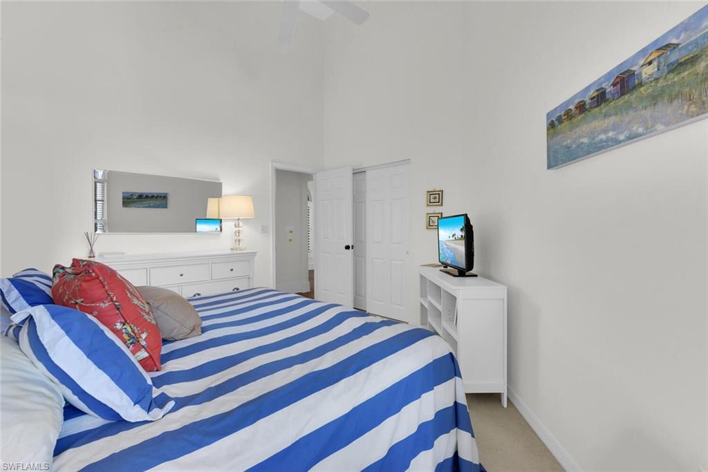 2124 Paget Circle, Unit 1 Naples, FL 34112 - Photo 14 of 31 a bedroom with a bed and a television