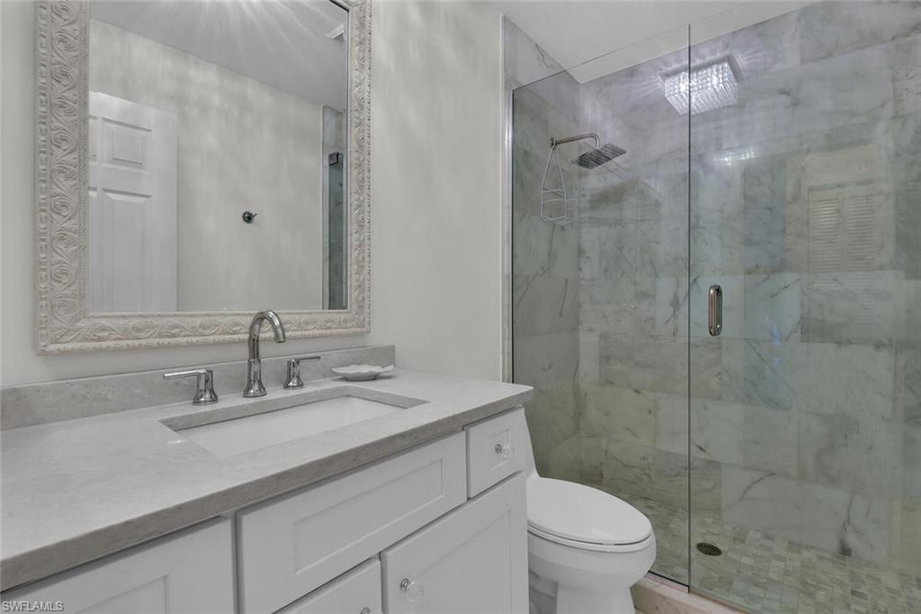 2124 Paget Circle, Unit 1 Naples, FL 34112 - Photo 16 of 31 a bathroom with a sink toilet and shower