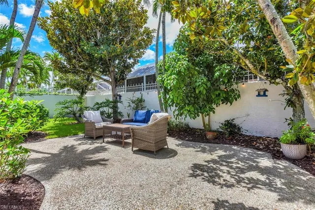 a view of a backyard with sitting area and garden