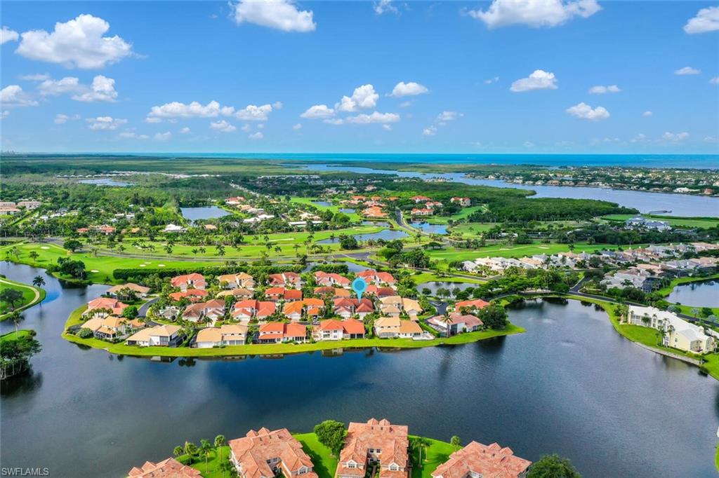 2124 Paget Circle, Unit 1 Naples, FL 34112 - Photo 27 of 31 a view of a lake with a lot of flower garden