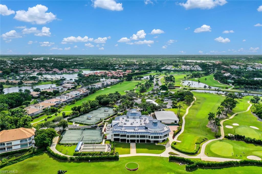 2124 Paget Circle, Unit 1 Naples, FL 34112 - Photo 29 of 31 a view of a swimming pool with lawn chairs and plants
